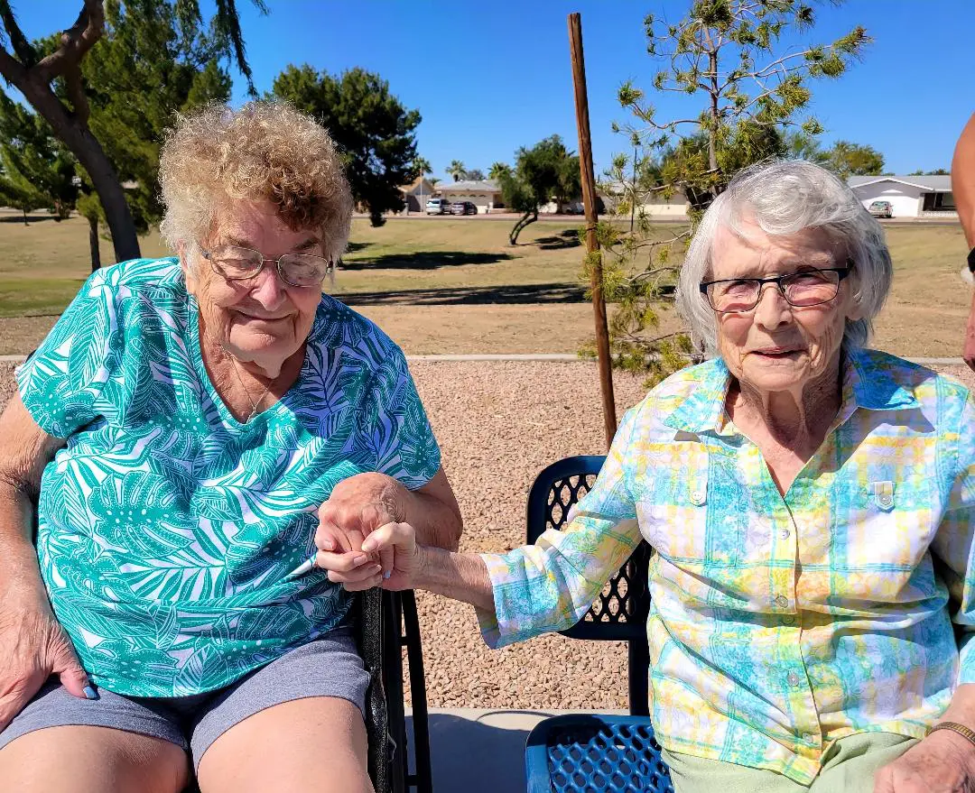 old women holding each others hand