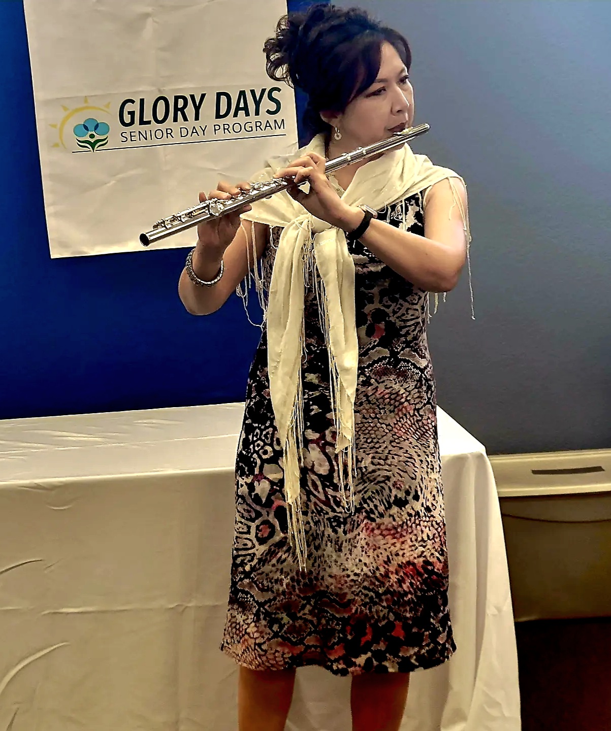 A young lady playing flute on the stage